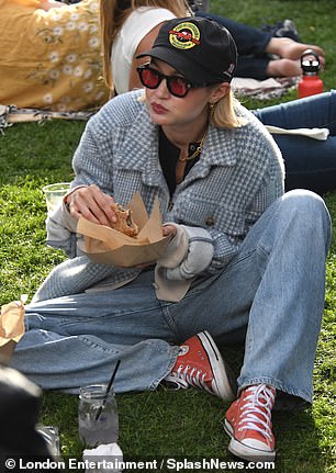 While Bradley demonstrated his cooking skills, Gigi was seen relaxing in the grass