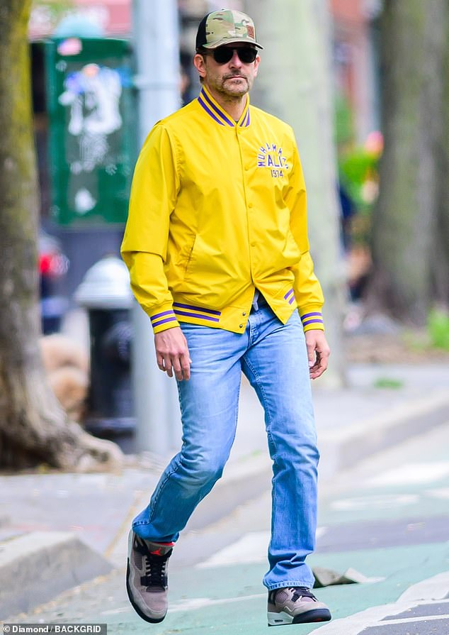 Bradley Cooper wore a bright yellow Muhammad Ali bomber jacket as he stepped out in New York City on Friday morning