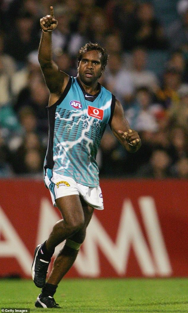 The footy great (pictured playing for Port Adelaide in 2005) was known for his hard-hitting play and is recognized as one of the best indigenous stars in AFL history.
