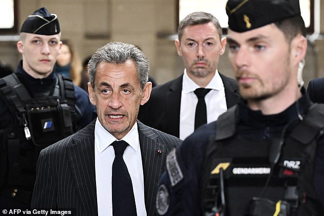 Former President of France Nicolas Sarkozy (center left) arrives at the courthouse in Paris on February 14, 2024 for the ruling in his appeal in the so-called Bygmalion case