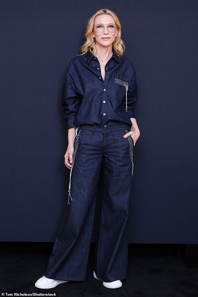 The Australian actress, 55, looked stunning as she tucked her navy blue shirt into matching wide leg trousers and trainers