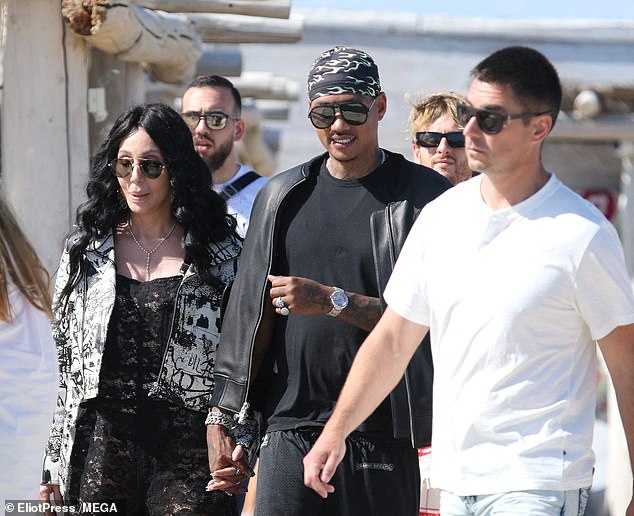 The couple were spotted holding hands as they landed in the internationally famous resort after a 50-mile helicopter flight