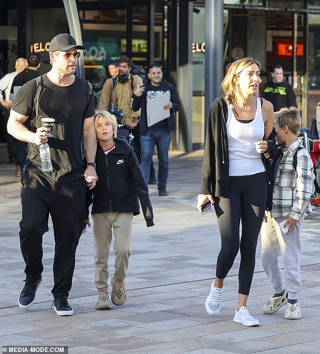 Chris Hemsworth, 40, returned to Australia on Monday with his three children - twin sons Sasha and Tristan, daughter India Rose, 12 - and a woman believed to be a nanny (all pictured)