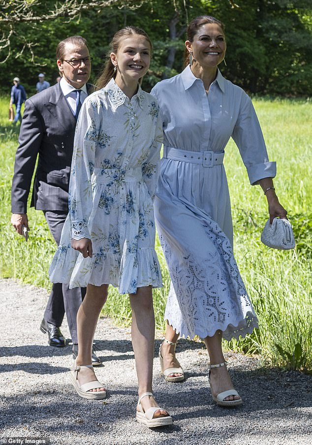 Crown Princess Victoria (pictured right) shared a sweet moment with her daughter Estelle (pictured left) as the Swedish royal family and her family attended the inauguration of a new sculpture in the Sculpture Park in Djurgården, Stockholm earlier today.