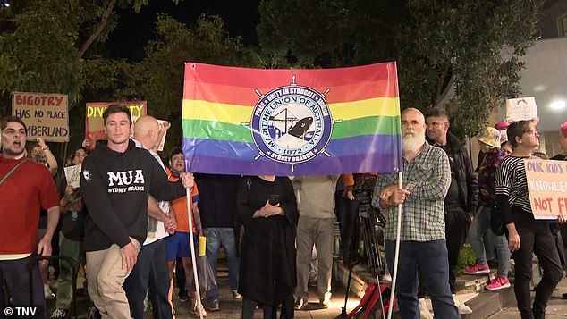 There was a tense standoff between opposing groups of protesters (pictured) outside the Cumberland Council chambers in Sydney's west on Wednesday evening.