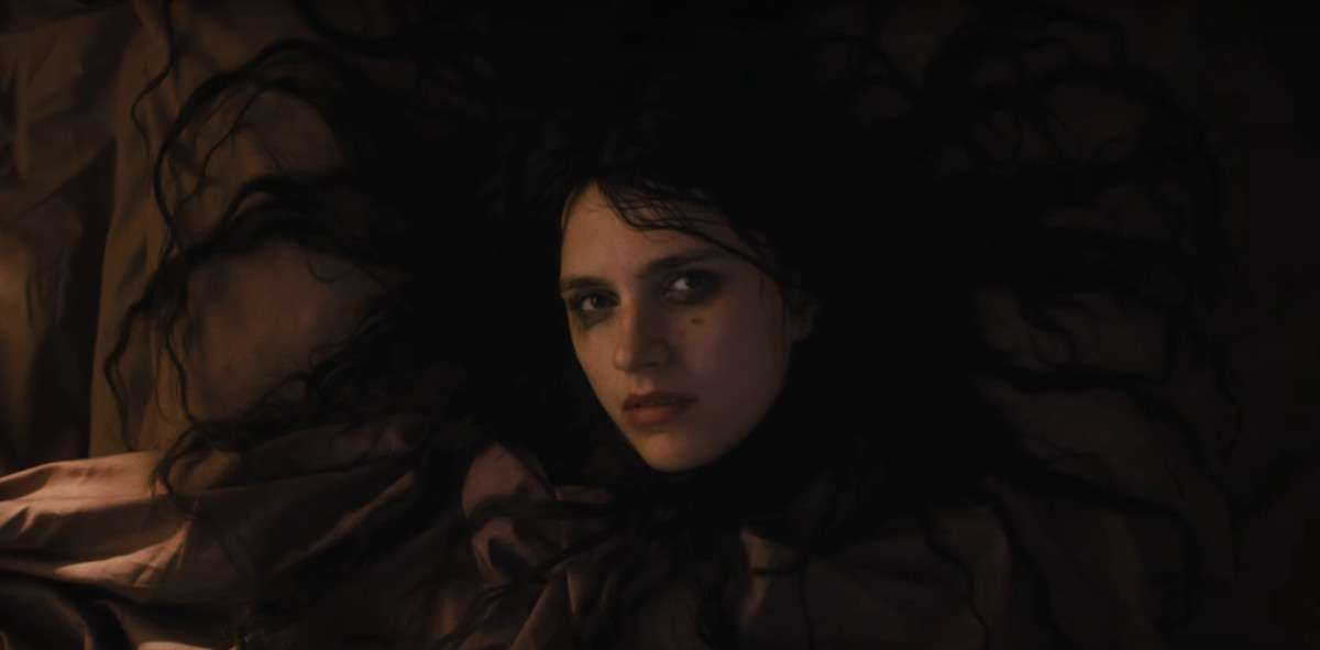 A woman lies down with her hair spread behind her in The First Omen