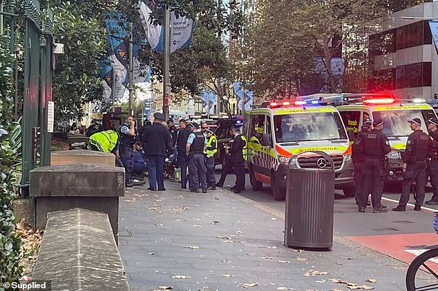 A police officer has been rushed to hospital with non-life-threatening head injuries after he was allegedly stabbed by a man in Sydney's CBD (pictured, emergency services on scene)