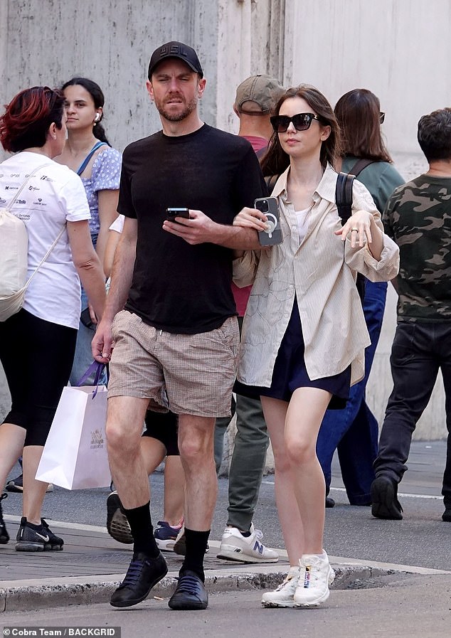 Emily In Paris star Lily Collins links arms with husband Charlie McDowell on a romantic trip to Rome on Wednesday