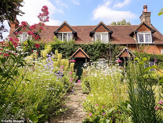 A cottage in Latimer, Buckinghamshire, with a lush spring garden that could make it more attractive to sell