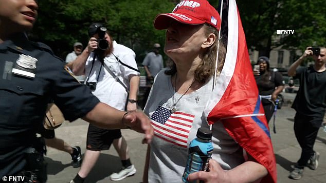 An apparently angry protester, when stopped by police, branded the woman a 'f***ing c**t' and told her to 'burn in hell you liberal f**k'