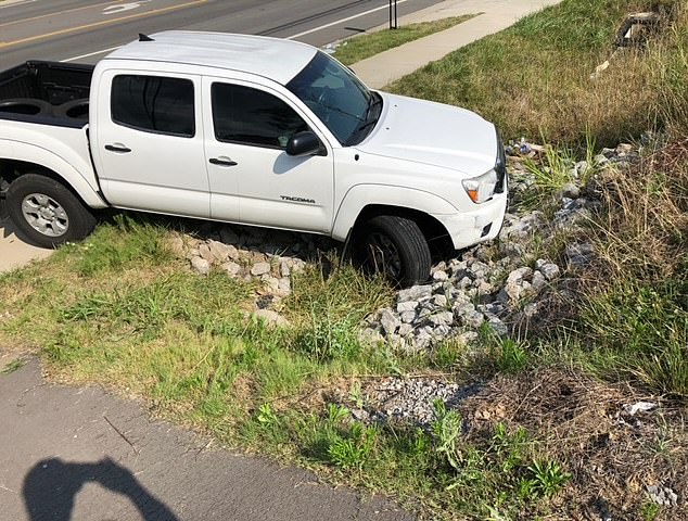 Grant's white Toyota Tocoma pickup truck pictured on the side of the road.  The incident took place at 8:40 am