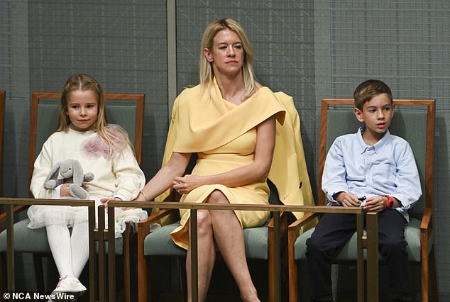 While Treasurer Jim Chalmers was the center of attention Tuesday night as he presented the federal budget, his wife Laura (pictured with two of their children) also cuts a very formidable figure.