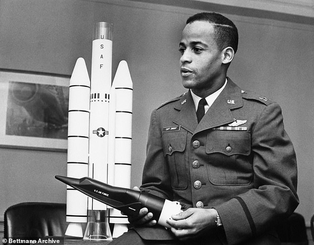 Pictured: Dwight looks at a model of the Titan III-X-20 Dyna-Soar combination during a visit to Air Force Headquarters in the capital in November 1963. The 31-year-old pilot was in the first class of 16 Air Force, Marine Corps and Navy pilots who experienced the new 