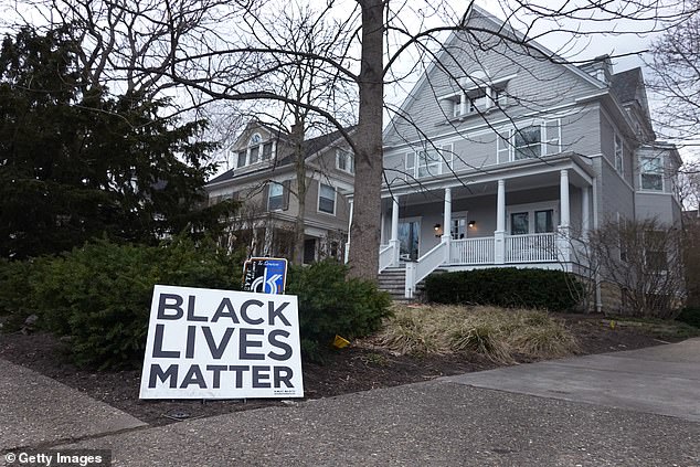 A Black Lives Matter sign stands in front of a home in Evanston, Illinois, the first U.S. city to launch a recovery plan