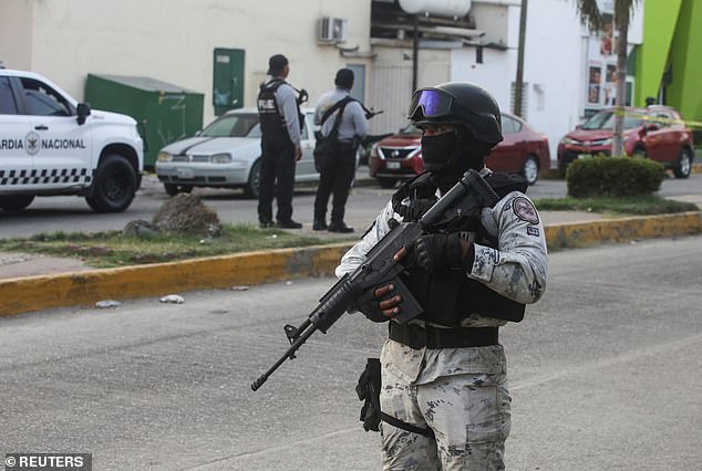 Security forces guard a crime scene near a market in Acapulco after gunmen shot dead five people and wounded another person on Thursday