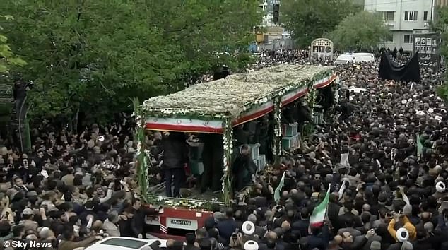 The bed of the truck was wide open so that the coffins could be displayed, decorated with images of the dead and covered with flowers