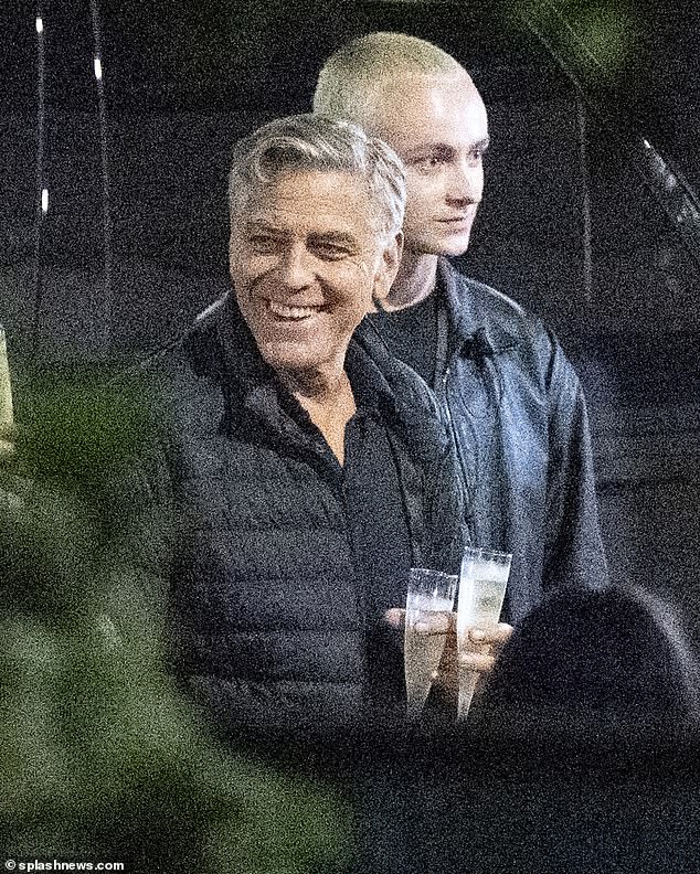 George Clooney grinned from ear to ear during his surprise birthday celebration while on the set of his new movie in Tuscany, Italy