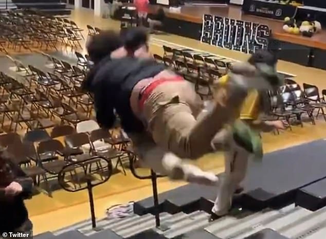 Shocking video shows the wild moment a fight between two high school boys results in one of the students being launched from the gymnasium bleachers