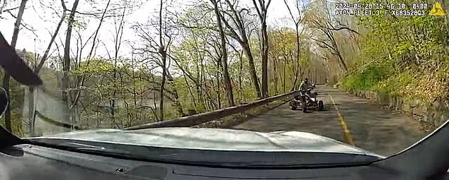 Video footage has captured the horrific moment an ATV driver loses control and crashes into a police car that had swerved into its lane to block pedestrians