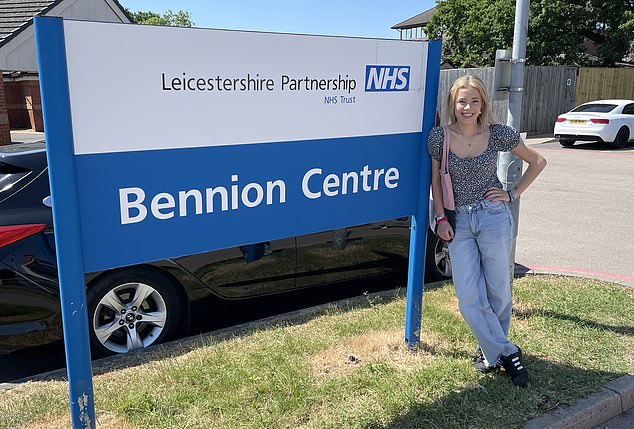 Claudia smiles after discharge from Glenfield Hospital in Leicester (pictured right)