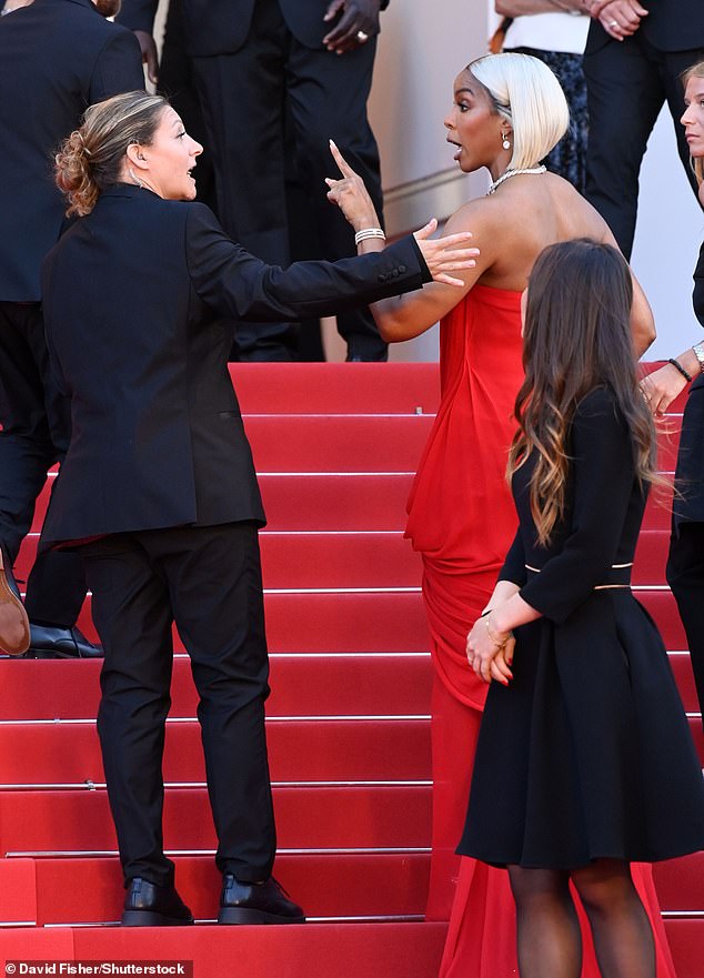 Kelly Rowland is pictured berating a security guard as she walks the red carpet at the Cannes Film Festival on Tuesday