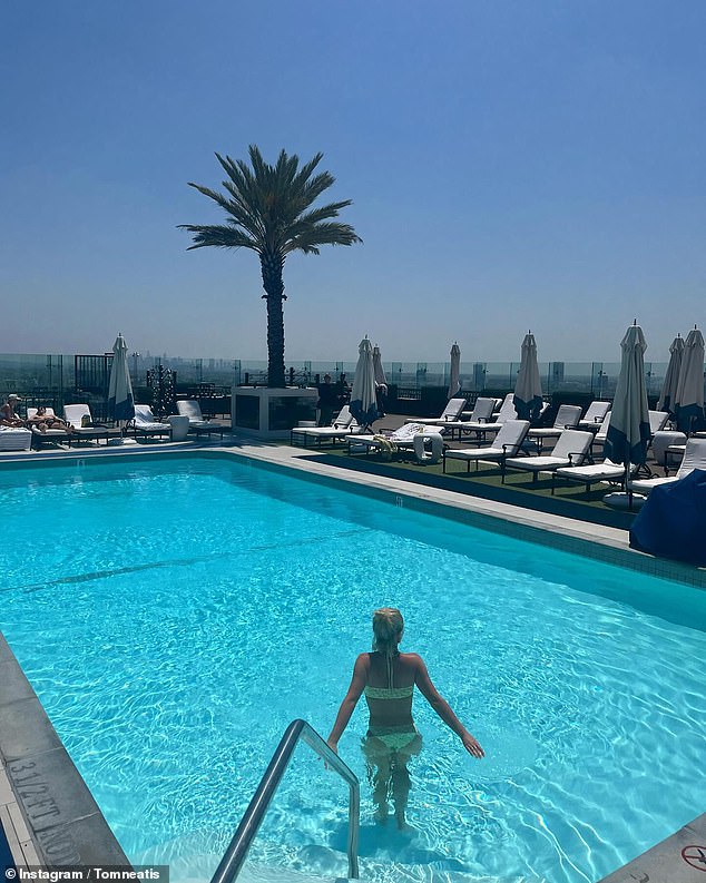 Tom posted a photo of Millie stepping into an empty pool, away from the camera and donning a yellow bikini as she cooled down from the hot weather