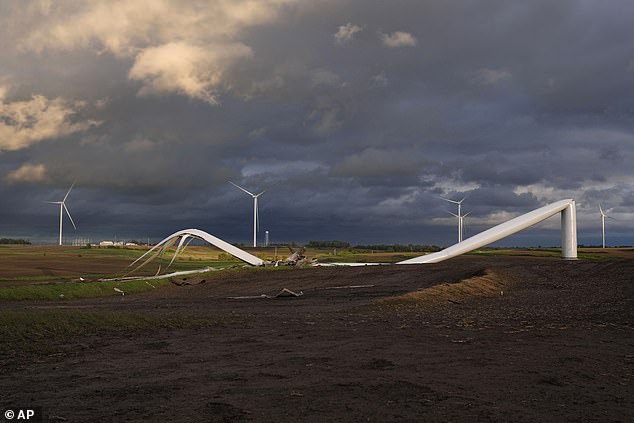 The remains of a tornado-damaged wind turbine hit the ground in a field near Prescott, Iowa, on Tuesday