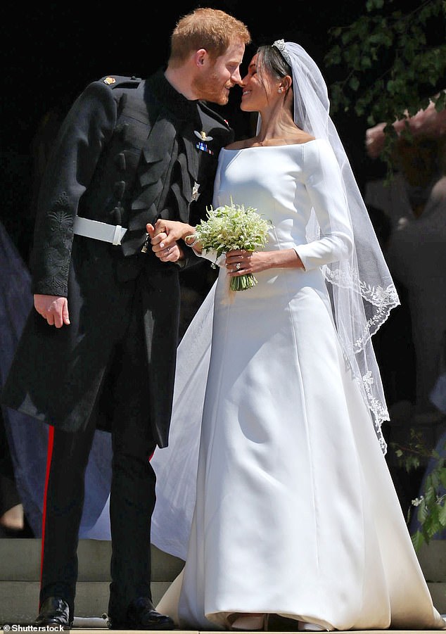 Meghan apparently used Carolyn's dress as one of her inspirations when choosing her dress.  Above: With Prince Harry after their wedding ceremony at Windsor's St George's Chapel