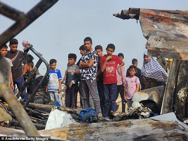 Palestinians see the devastation after Israel bombed their tents and shelters in Rafah, Gaza, on May 27