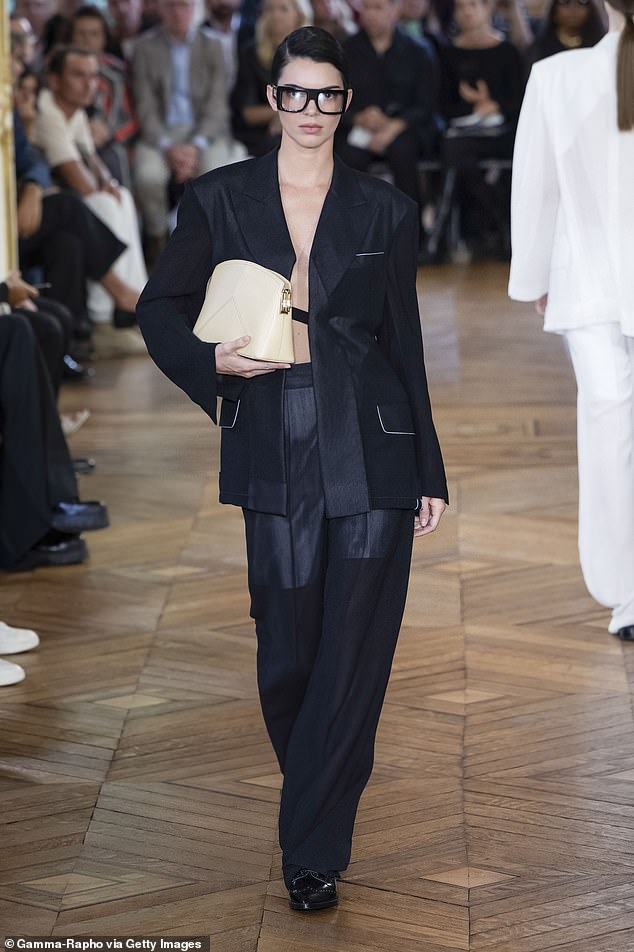 The 28-year-old supermodel sported dramatic square glasses, her hair slicked back and a black suit designed by the former Spice Girl for her Spring/Summer 2024 show last year.