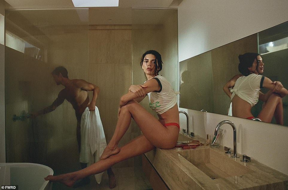 Kendall Jenner shocked fans with her new FWRD summer campaign released on social media on Monday.  One of the images showed the 28-year-old model sitting on a marble countertop of a modern-looking bathroom with a naked man in the shower