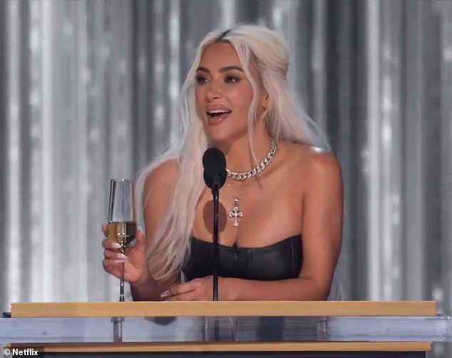 Kardashian sported blonde locks as she held a champagne flute at the event in Southern California