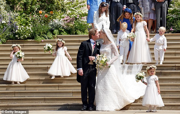 Thomas Kingston kisses his new bride on the steps of St George's Chapel on a gloriously sunny day in the presence of almost all the senior members of the Royal Family, May 2019