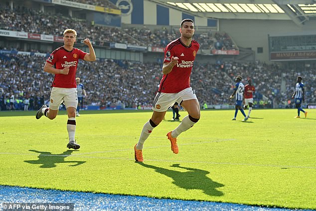 Diogo Dalot (right) drives off after scoring Manchester United's opener against Brighton