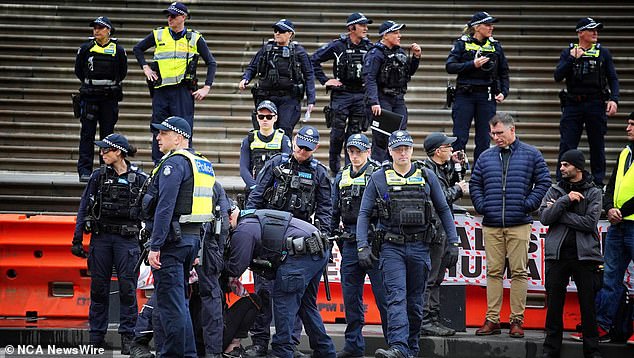 Victorian police formed a barrier to help prevent violence as the Nakba rally, which started around midday, joined the Never Again is Now rally in Melbourne CBD (pictured)