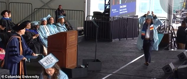 At Columbia University's commencement on Friday, a graduate student walked onto the stage with her hands tied above her head