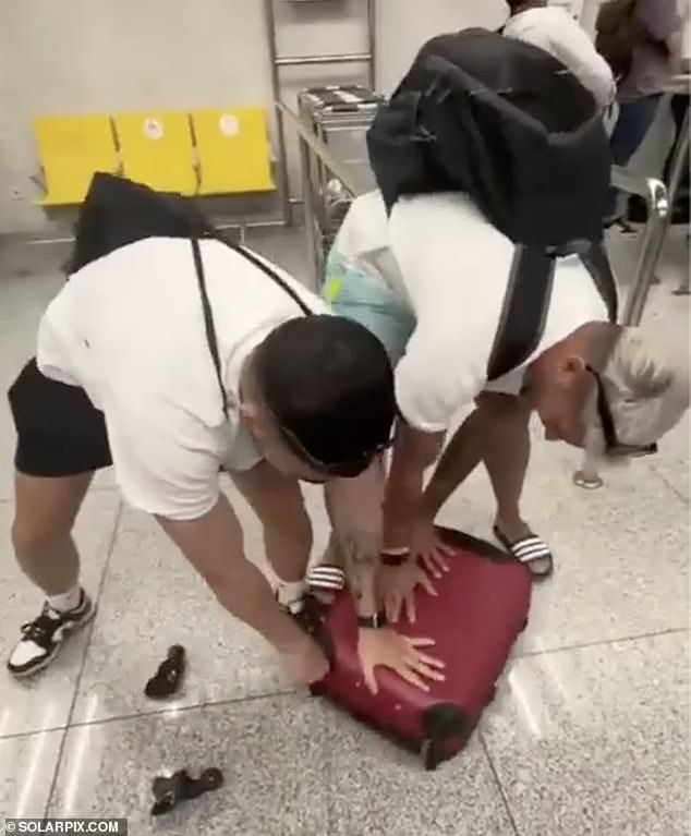 The travelers are seen ripping the legs off one of their suitcases