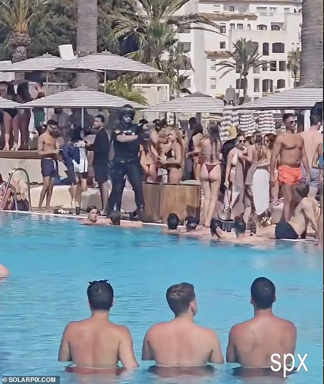 A police officer appears to guide holidaymakers out of the way during the sudden 'checks'