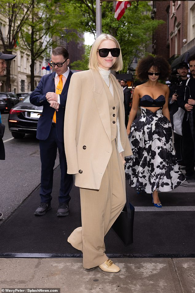 Naomi Watts donned a three-piece beige pantsuit over a white turtleneck to check into the Mark Hotel in Midtown Manhattan on Sunday, ahead of Monday's Met Gala