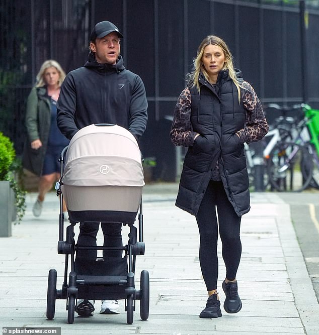 Olly Murs and his wife Amelia enjoyed a walk with their newborn Madison in London on Friday after his daughter attended her first live show at the O2 earlier this week at just two weeks old