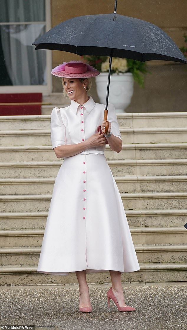 Zara looked chic in a white dress, channeling my Fair Lady, paired perfectly with an umbrella
