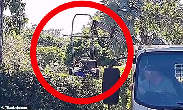 A Queensland dad has turned heads with a video of him pruning his hedges with an invention involving his truck and a crane