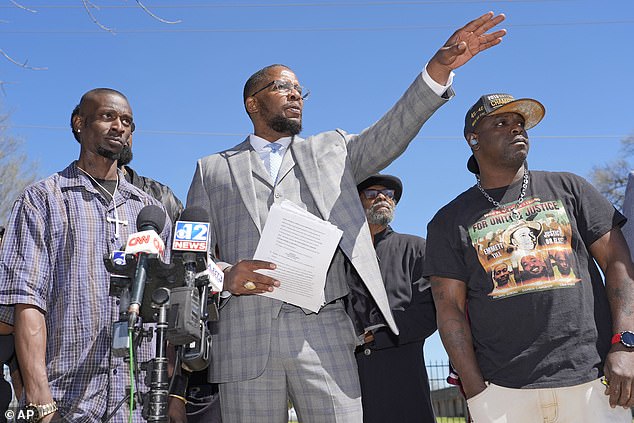 Michael Corey Jenkins, left, and Eddie Terrell Parker, right, stand next to lead attorney Malik Shabazz as they call on a federal judge to impose the harshest possible sentences