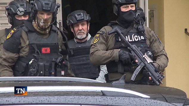 The pensioner (pictured center) appeared in court accused of attempting to assassinate the Slovak Prime Minister.  The Mail on Sunday was given exclusive access to his literary works