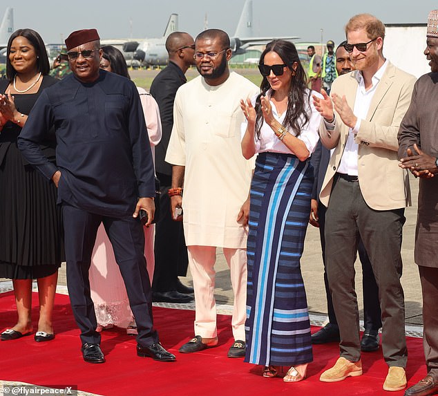 Dr.  Allen Onyema, founder of Nigerian airline Air Peace, provided the Sussexes with free flights during their three-day tour of Nigeria to celebrate 10 years of Harry's Invictus Games (left dresses in navy blue)