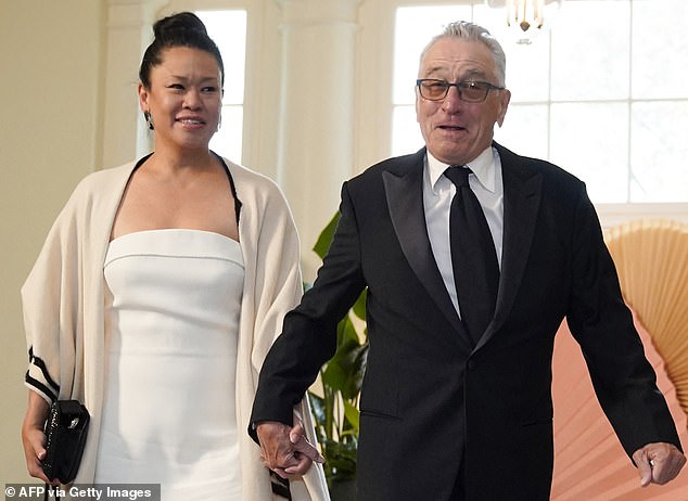 Actor Robert De Niro (right) provided the voiceover for a new Biden campaign ad released Friday.  De Niro appeared with his girlfriend Tiffany Chen (left) at the state dinner with Japan last month