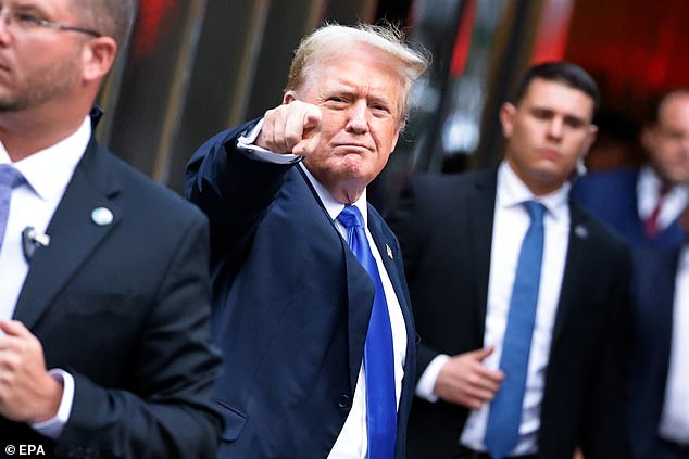 Trump gestures to the media and crowd outside Trump Tower after a jury found him guilty on all 34 counts in his criminal trial