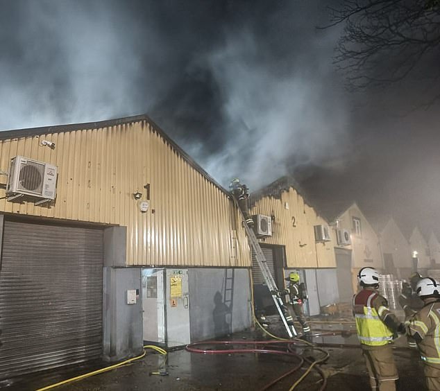 Russia has called British claims that Moscow was involved in a suspected arson at a Ukrainian aid center in London (pictured as firefighters worked at the scene) 'absurd'.