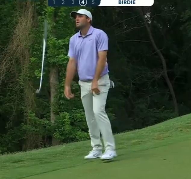 Scottie Scheffler turned his putter over in disgust after his putt rolled through the hole on the 11th