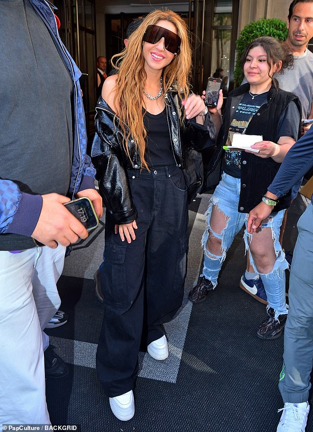 Shakira, 47, looked chic in a shiny black jacket and oversized sunglasses in New York on Tuesday, the day after she made her stunning Met Gala debut